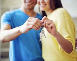 Young Husband and Wife Holding Keys to Their New Home